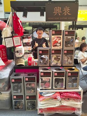 Heng Suay Eating House booth stacked with boxed merchandise